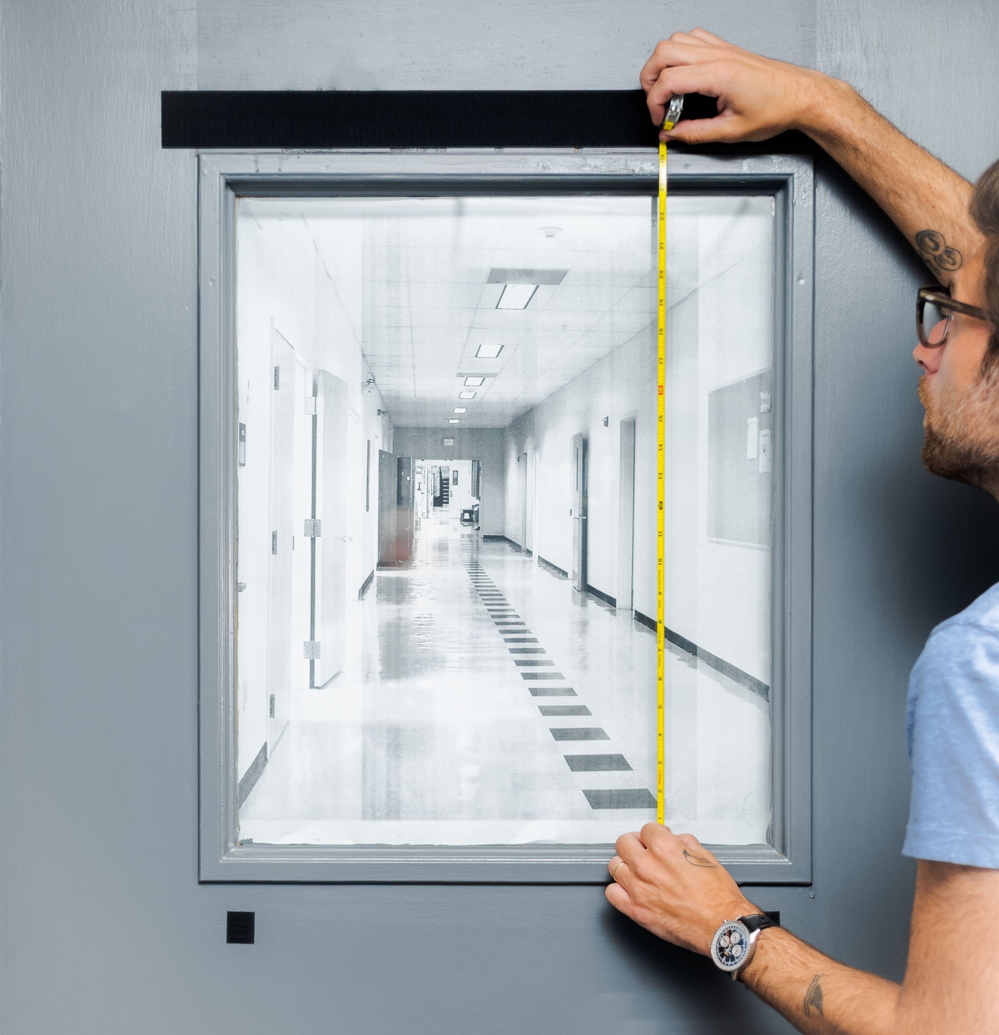 Measuring the length of a classroom door window.