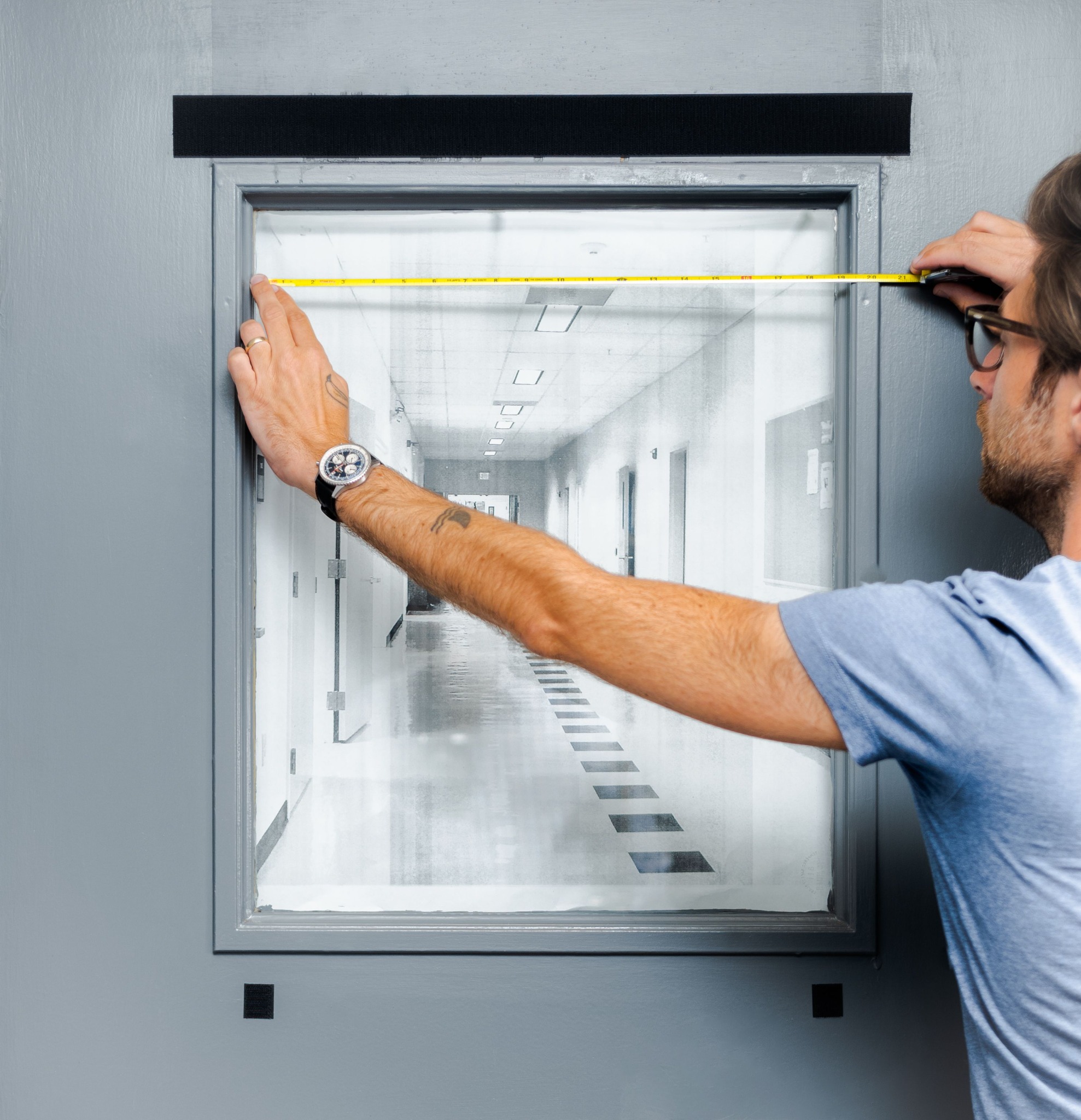 Measuring the width of a classroom door window.